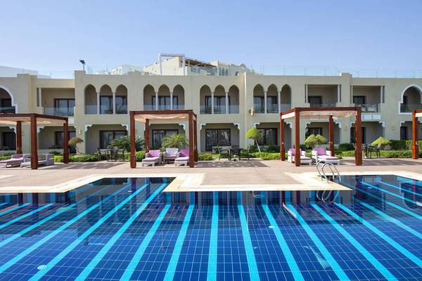 Außenbereich des Sunrise Arabian Beach Resorts mit Swimmingpool und Loungebereichen.