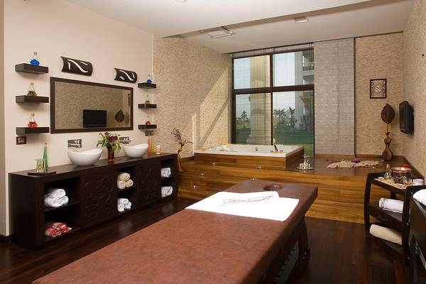 Spa-Bereich im Defne Kumul Deluxe Hotel mit Badewanne, Schränken und Massagetisch.
