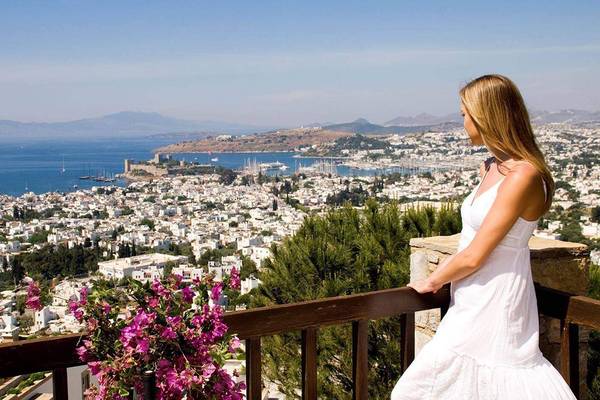 Frau auf dem Balkon im Marmara Bodrum mit Blick auf die Stadt und das Meer