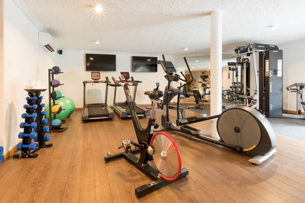 Fitnessraum im Seasense Boutique Hotel & Spa mit Laufbändern, Rudergeräten und Hanteln.