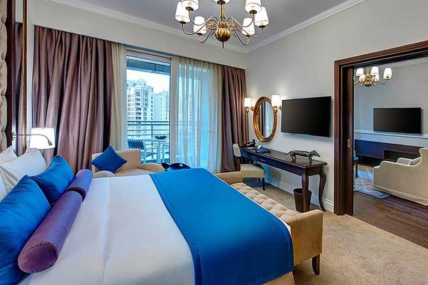Suite im Dukes The Palm, a Royal Hideaway Hotel mit Bett, Fernseher und Schreibtisch.