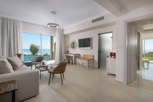 Wohnzimmer im Rodos Palladium Leisure & Wellness mit Meerblick, Möbeln und Fernseher.