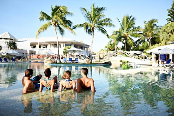 Vier Personen schwimmen in einem Pool im Royalton Hicacos Resort & Spa.