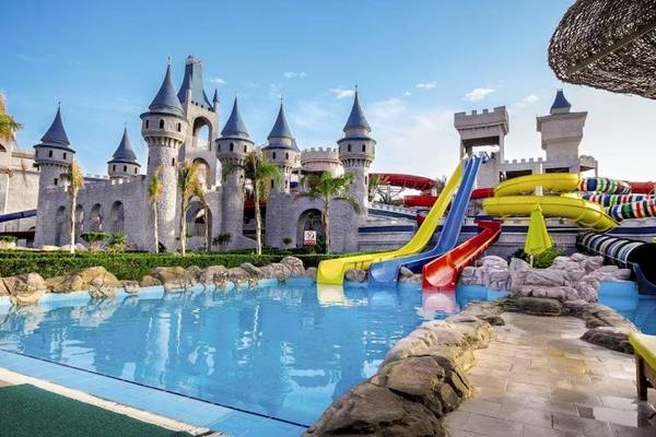 Wasserpark im Serenity Alma Heights Hotel mit bunten Rutschen und einem großen Schwimmbecken.
