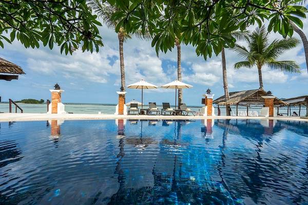 Außenpool des Dara Samui Beach Resort mit Sonnenliegen und Sonnenschirmen.