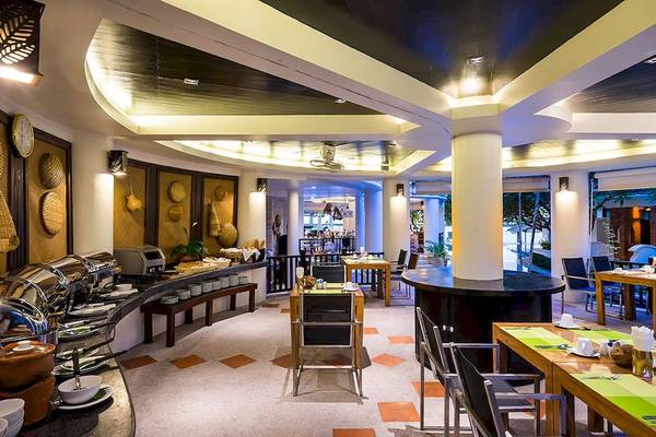 Innenansicht des Restaurants im Dara Samui Beach Resort mit Tischen, Stühlen und Buffet.