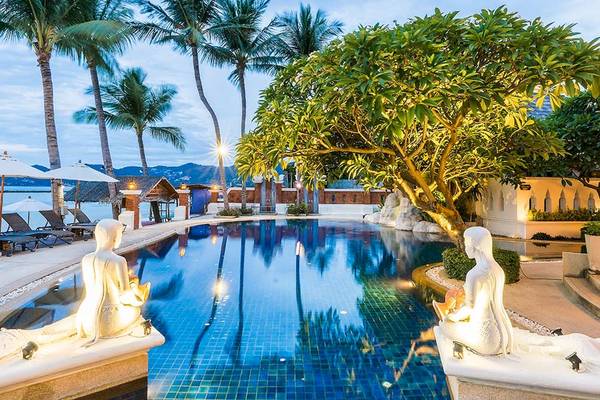 Außenpool mit Statuen im Dara Samui Beach Resort mit Blick auf den Strand.