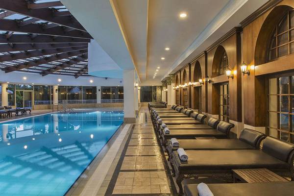 Im Delphin Diva Premiere Hotel gibt es einen großen Poolbereich mit Liegestühlen und einer Glasüberdachung.