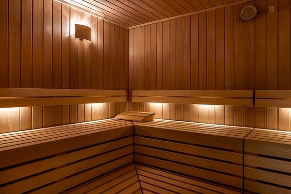 Innenansicht der Sauna im Euphoria Resort mit Holzwänden und Beleuchtung.