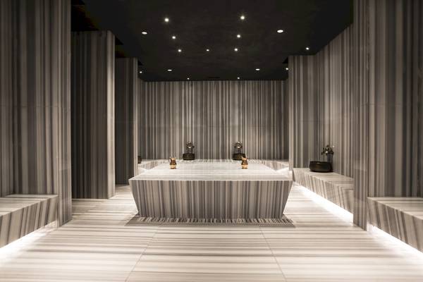 Innenansicht der Sauna im Voyage Sorgun Hotel mit Marmorwänden und zentralen Wasserbecken.