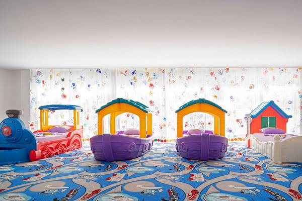 Ein Kinderzimmer im Voyage Sorgun Hotel mit verschiedenen thematischen Spielbetten und einer farbenfrohen Wanddekoration.