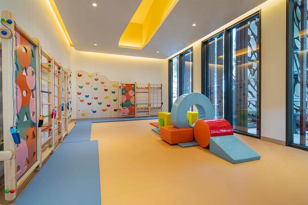 Spielbereich im Voyage Belek Golf & Spa Hotel mit bunten Spielgeräten und großen Fenstern.