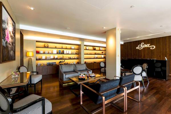 Spa-Lounge im Le Meridien Phuket Beach Resort mit Möbeln und Holzboden.