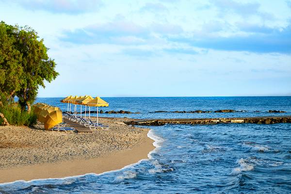 Strand des Serita Beach Hotels mit Sonnenliegen, Sonnenschirmen und Meer