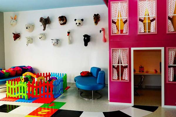 Ein farbenfrohes Kinderzimmer im Sueno Hotels Beach Side mit vielen Tiermasken an der Wand.