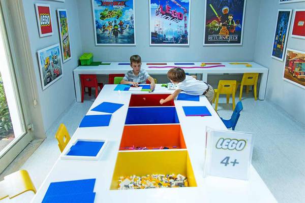 Zwei Kinder bauen Legos in einem Raum des Sueno Hotels Beach Side.