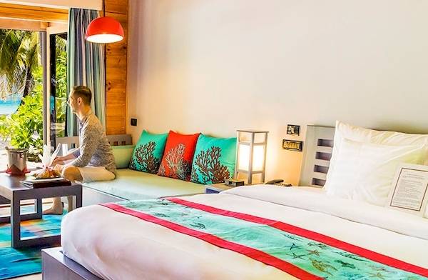 Suite im Meeru Island Resort & Spa mit Blick auf das Meer und einen offenen Balkon.