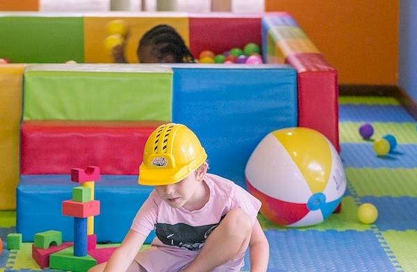 Kinder im Meeru Island Resort spielen in einem bunten Spielbereich mit Bällebad und Spielzeug.