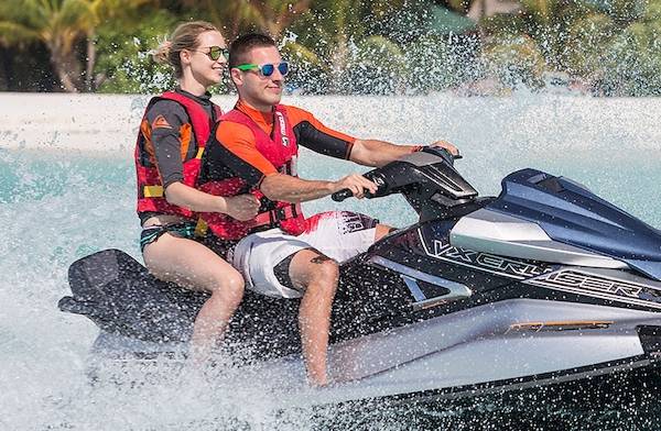 Zwei Personen genießen eine Jetski-Fahrt im Meer vor dem Meeru Island Resort & Spa.
