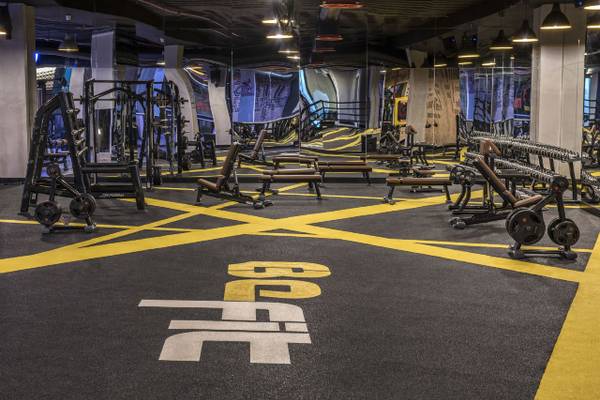 Fitnesscenter im Delphin BE Grand Resort mit gelben Linien und großen Buchstaben.