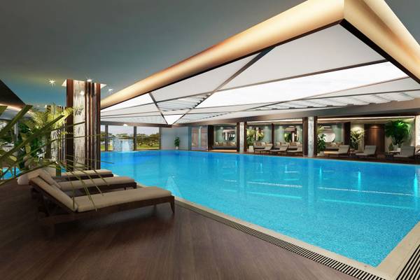Illustration des Innenpools im Delphin BE Grand Resort mit Lounge-Bereich und beleuchteter Decke