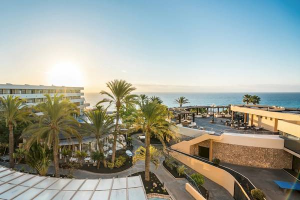 Aussicht auf das Iberostar Playa Gaviotas Park Hotel mit Sonnenuntergang und Ozean im Hintergrund.