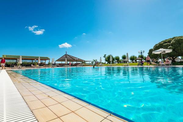 Apollo Beach Hotel Pool im Freien mit Sonnenschirmen und Liegestühlen