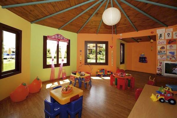 Kinderzimmer im Minoa Palace Resort & Spa mit bunten Möbeln und Spielzeug.