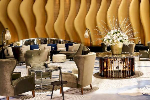 Lobby des Grand Hyatt Abu Dhabi Hotel mit geschwungenen Wänden und Möbeln.