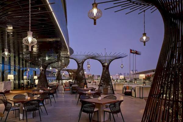 Außenterrasse des Grand Hyatt Abu Dhabi Hotel mit abendlicher Beleuchtung und Sitzgelegenheiten.
