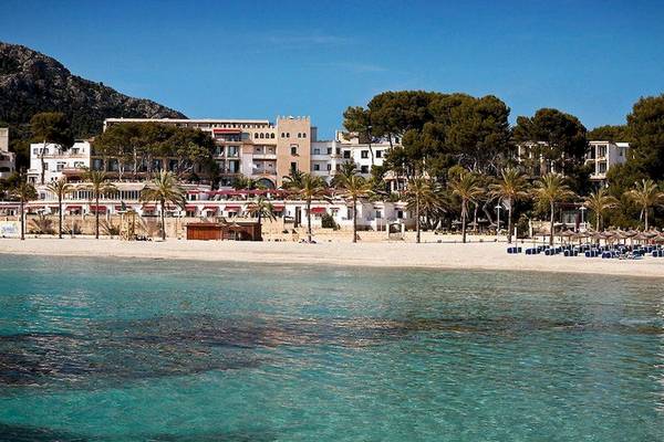 Strand mit Hotel Secrets Mallorca Villamil Resort & Spa und Berg im Hintergrund
