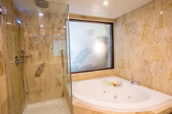 Luxuriöses Badezimmer mit Badewanne und separater Dusche im Impressive Premium Punta Cana Hotel.