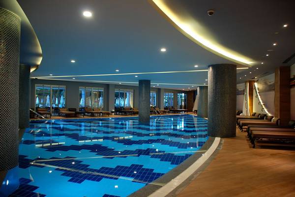 Innenpool im Botanik Platinum Hotel mit geometrischem Bodenmuster und Loungebereich