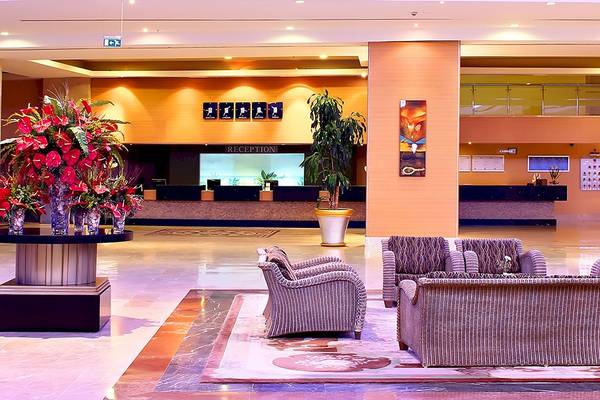 Empfangsbereich des Miracle Resort Hotels mit Blumen, Pflanzen und Sitzmöbeln