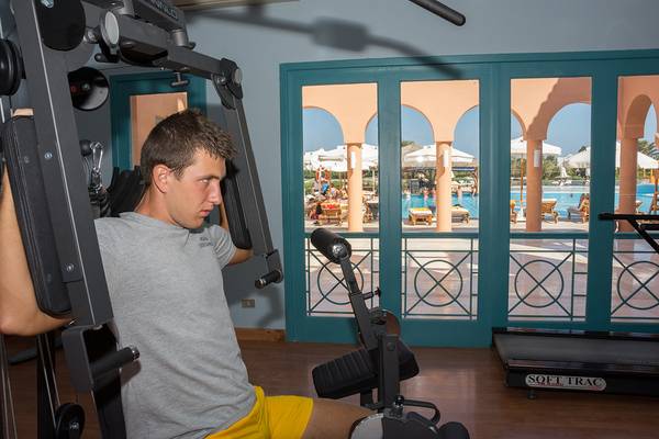 Mann im Fitnessbereich des Chedi El Gouna, der an einem Gerät trainiert