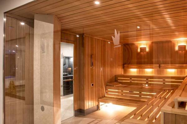 Innenansicht der Sauna im Guayarmina Princess Hotel mit Holzbänken und warmem Licht.