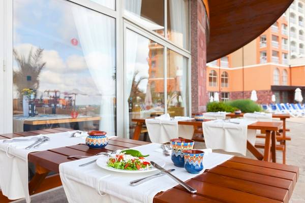 Außenbereich des Sol Luna Bay Hotels mit Tisch und Teller Salat.