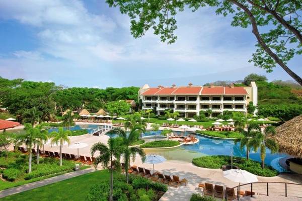 Außenansicht des Westin Reserva Conchal, einem All-Inclusive Golf Resort mit Swimmingpool und vielen Liegestühlen.