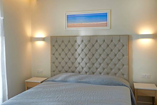 Schlafzimmer mit Bett und Dekor im Sunrise Beach Hotel in Zypern