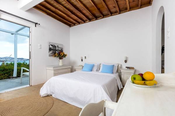 Schlafzimmer im Rhenia Mykonos Hotel mit Blick auf den Garten und das Meer.