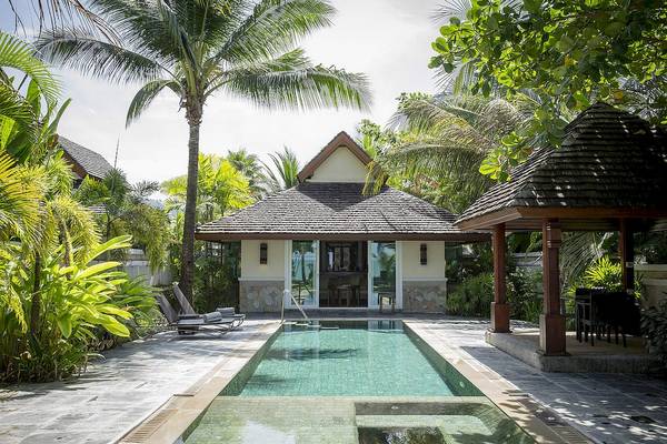 Villa im Robinson Khao Lak Hotel mit Swimmingpool und Liegen vor der Tür