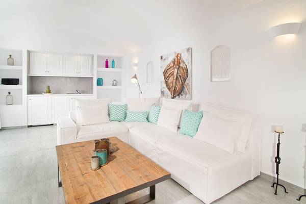 Weißes Wohnzimmer in den Agali Houses mit Couch, Holztisch und Dekor