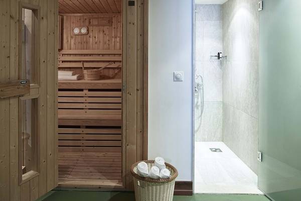 Sauna und Dusche im Creta Maris Resort mit Holzelementen und bequemen Liegeflächen.