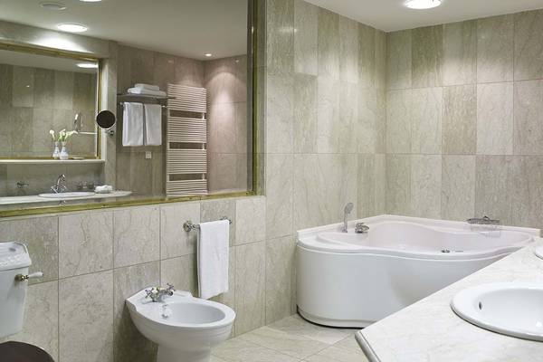Badezimmer im Creta Maris Resort mit Badewanne, Dusche und Waschbecken.