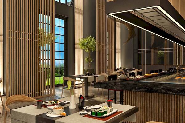 Innenansicht des Restaurants im Rixos Premium Saadiyat Island Hotel mit Tisch, Sushi und offenem Küchenbereich.