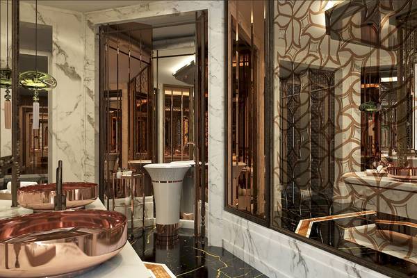 Badezimmer im Rixos Premium Saadiyat Island mit Kupferarmaturen und Marmorwänden.