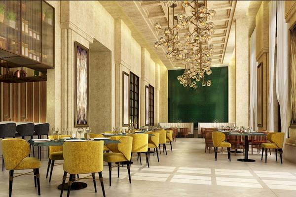 Innenansicht des Restaurants im Rixos Premium Saadiyat Island Hotel mit gelben Stühlen und grüner Wand.