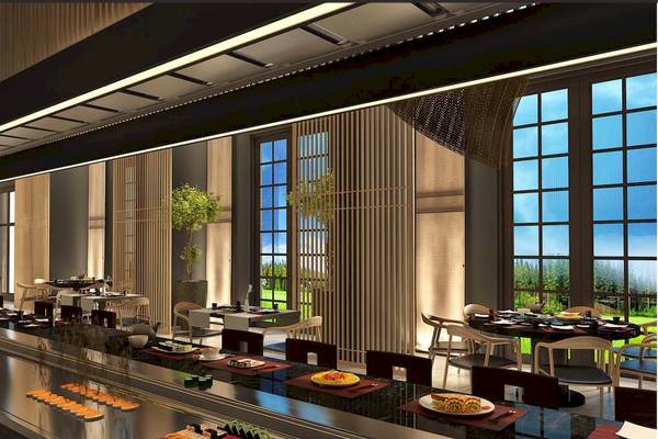 Innenansicht des Rixos Premium Saadiyat Island Restaurants mit Sushi-Bar, Tischen und Fenstern.