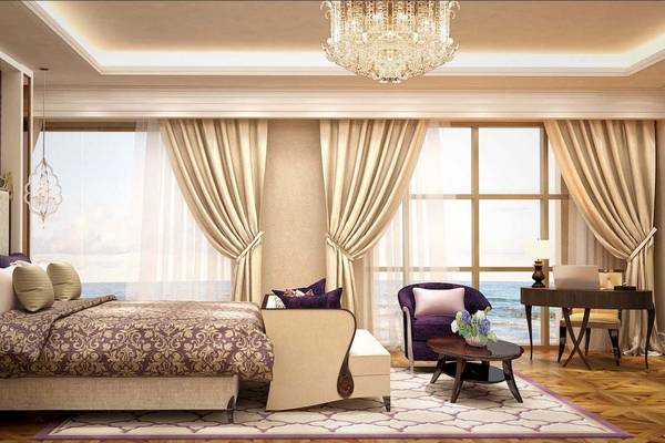 Luxuriöses Schlafzimmer im Rixos Premium Saadiyat Island mit großem Bett, eleganter Einrichtung und Meerblick.