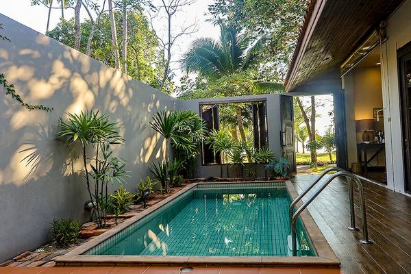 Privater Poolbereich des Saree Samui Resorts, umgeben von Pflanzen und Holzboden.